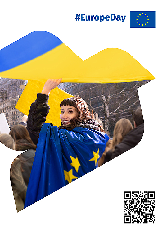 image of a girl in a crowd, waving and wearing an EU flag. #EuropeDay