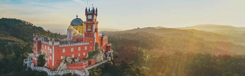 Pena Palace, a UNESCO World Heritage Site, sits atop a peak in the Sintra Mountains. © AdobeStock 