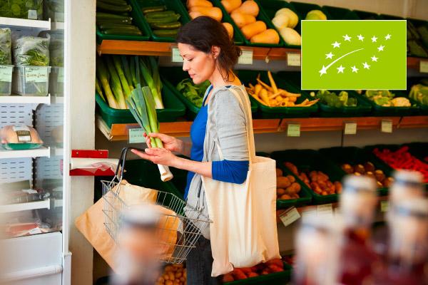 A lady shopping in a bio/organic supermarket. EU organic logo displayed