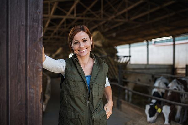 a female farmer standing in a cowshed